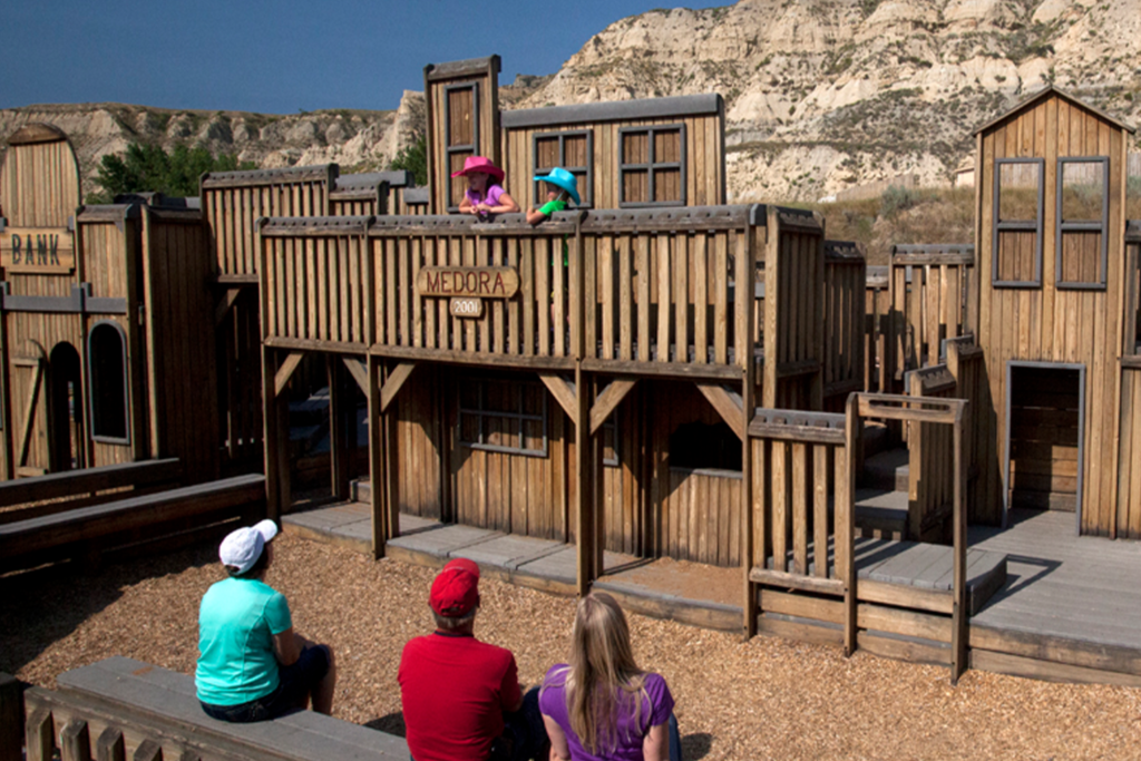 An aerial view of the Medora Children's Park, prominently features the wooden façade of a replica wild-west town, in Medora, ND.