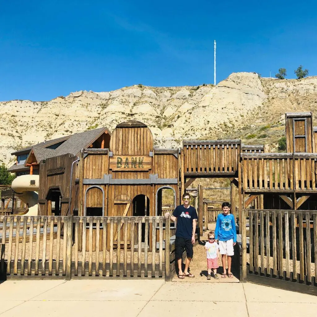The Medora Children's Park, prominently features the wooden façade of a replica wild-west town, in Medora, ND.