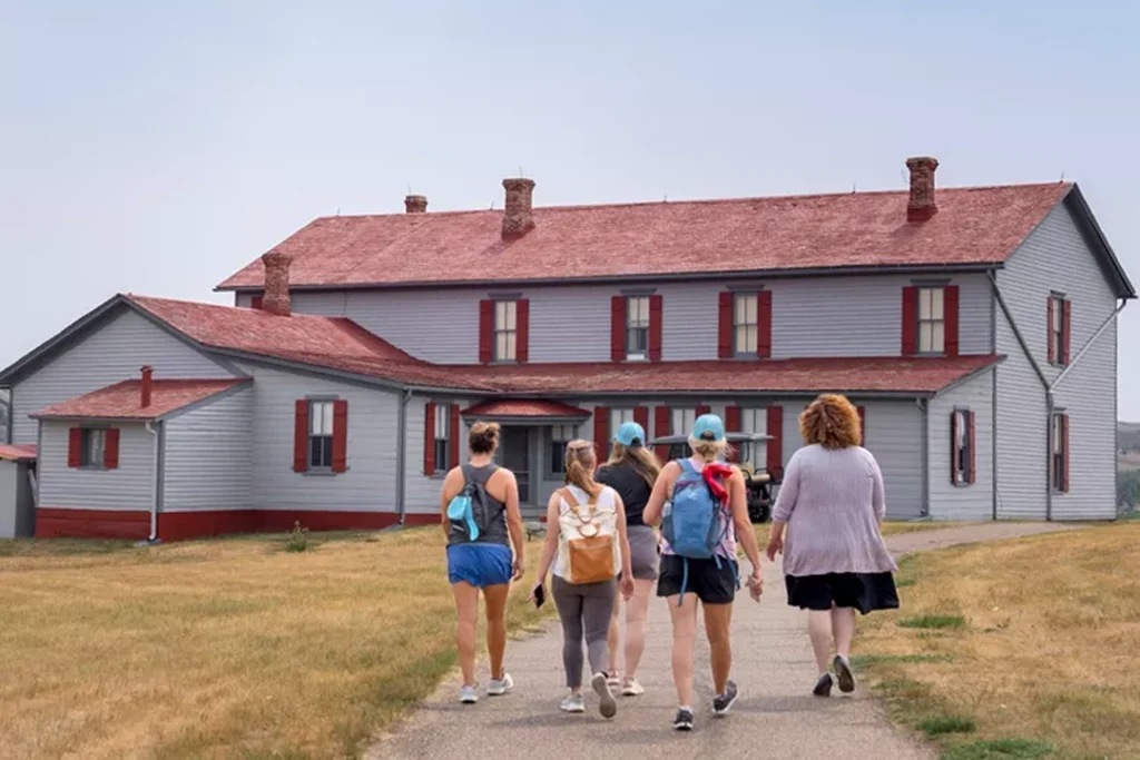 A group of women walk on a paved path towards the Chateau de Mores a popular historic attraction in Medora, North Dakota