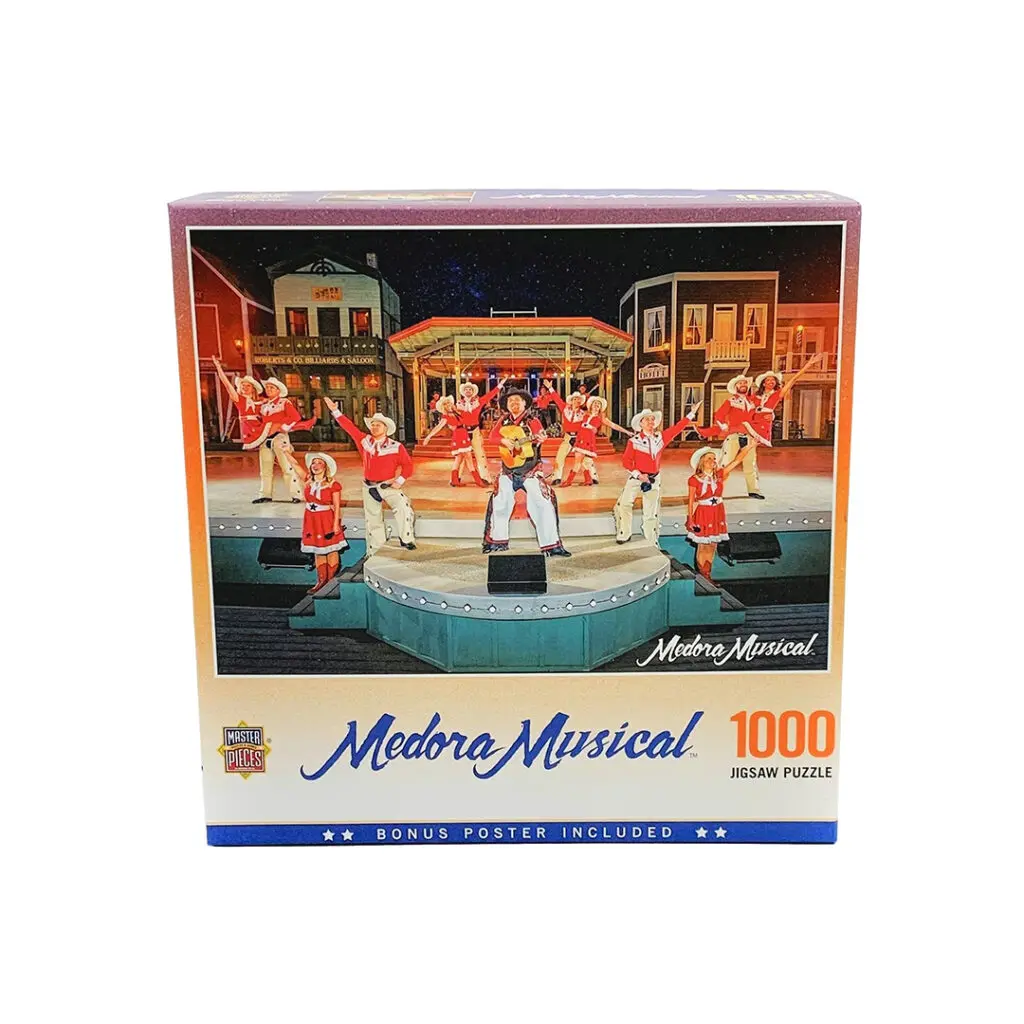 A box of a Medora Musical puzzle which shows a picture with performers posing on stage at the Medora Musical, a popular attraction in Medora, North Dakota which can be found in stores in Medora, North Dakota