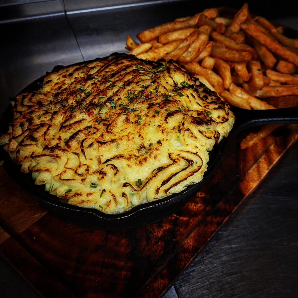 A skillet of Guinness Pie and french fries sits on a plate. A special menu item for St. Patrick's Day at Theodore's Dining Room in Medora, North Dakota