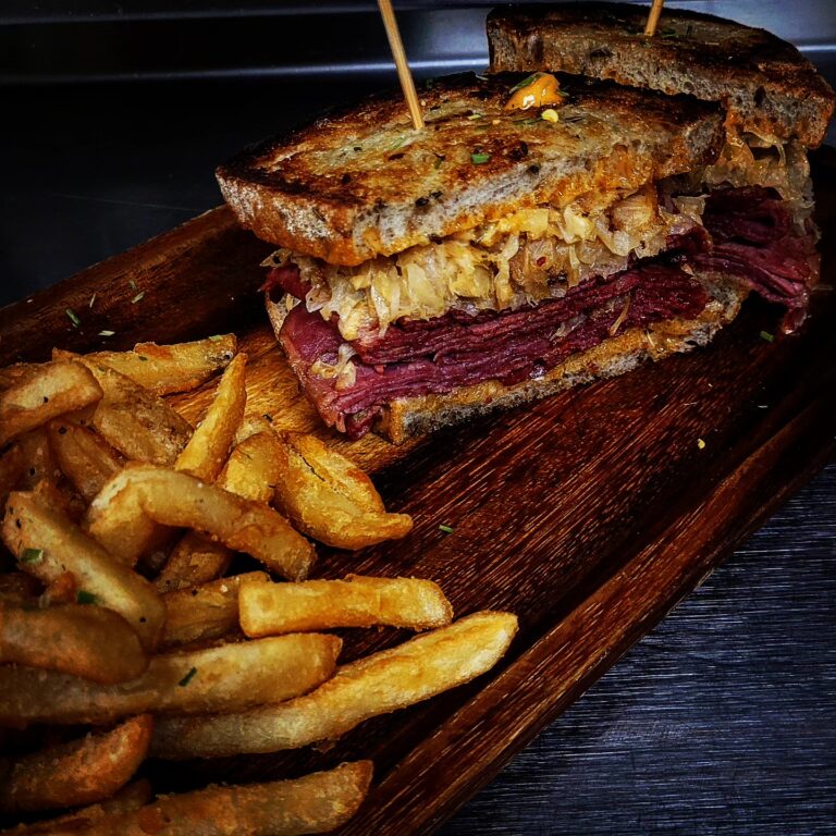 A reuben sandwich sits on a plate with french fries. A special menu item for St. Patrick's Day at Theodore's Dining Room in Medora, North Dakota