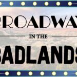 A graphic with a picture of Badlands in Medora, North Dakota overlayed with marquee lights and the text "Broadway in the Badlands" a show featuring Broadway music and show tunes playing in Medora, North Dakota May 17 and 18
