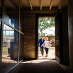Two children run through the front door, into Theodore Roosevelt's historic cabin in Theodore Roosevelt National Park, Medora, ND