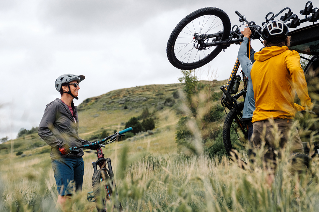 Three bikers load up their bikes into a car on the Maah Daah Hey Trail a popular outdoor attraction for mountain biking and hiking in Medora, North Dakota