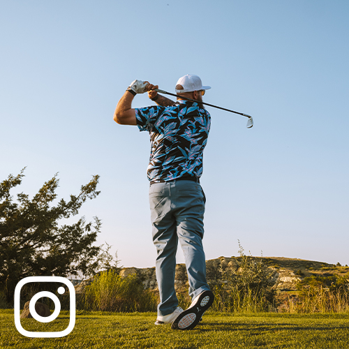 man swinging golf club at Bully Pulpit Golf Course in Medora