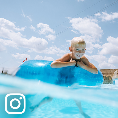 young boy floating in innertube at Medora Point to Point Park