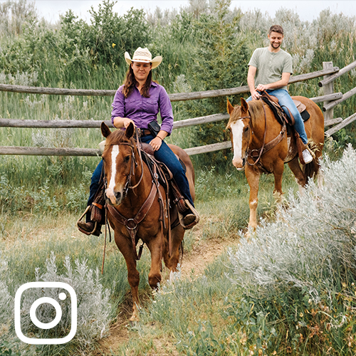 two people horseback riding in Medora