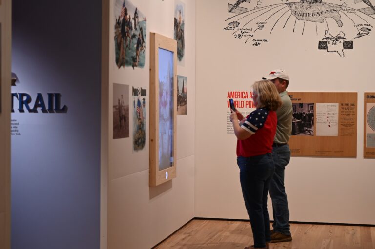 A couple interacting with an AI exhibit.